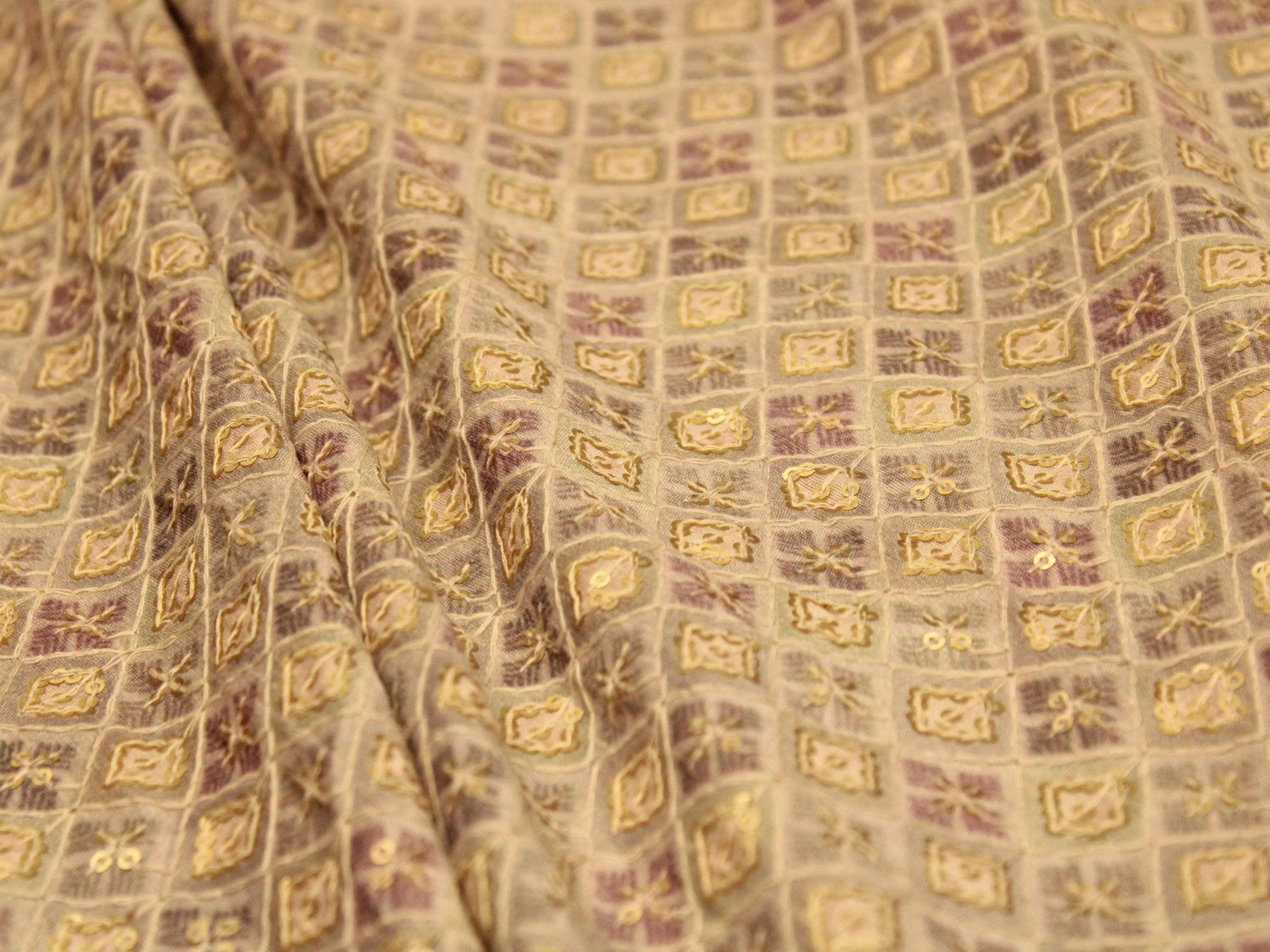 Grey silk canvas digital print fabric with intricate gold square motifs and textured folds