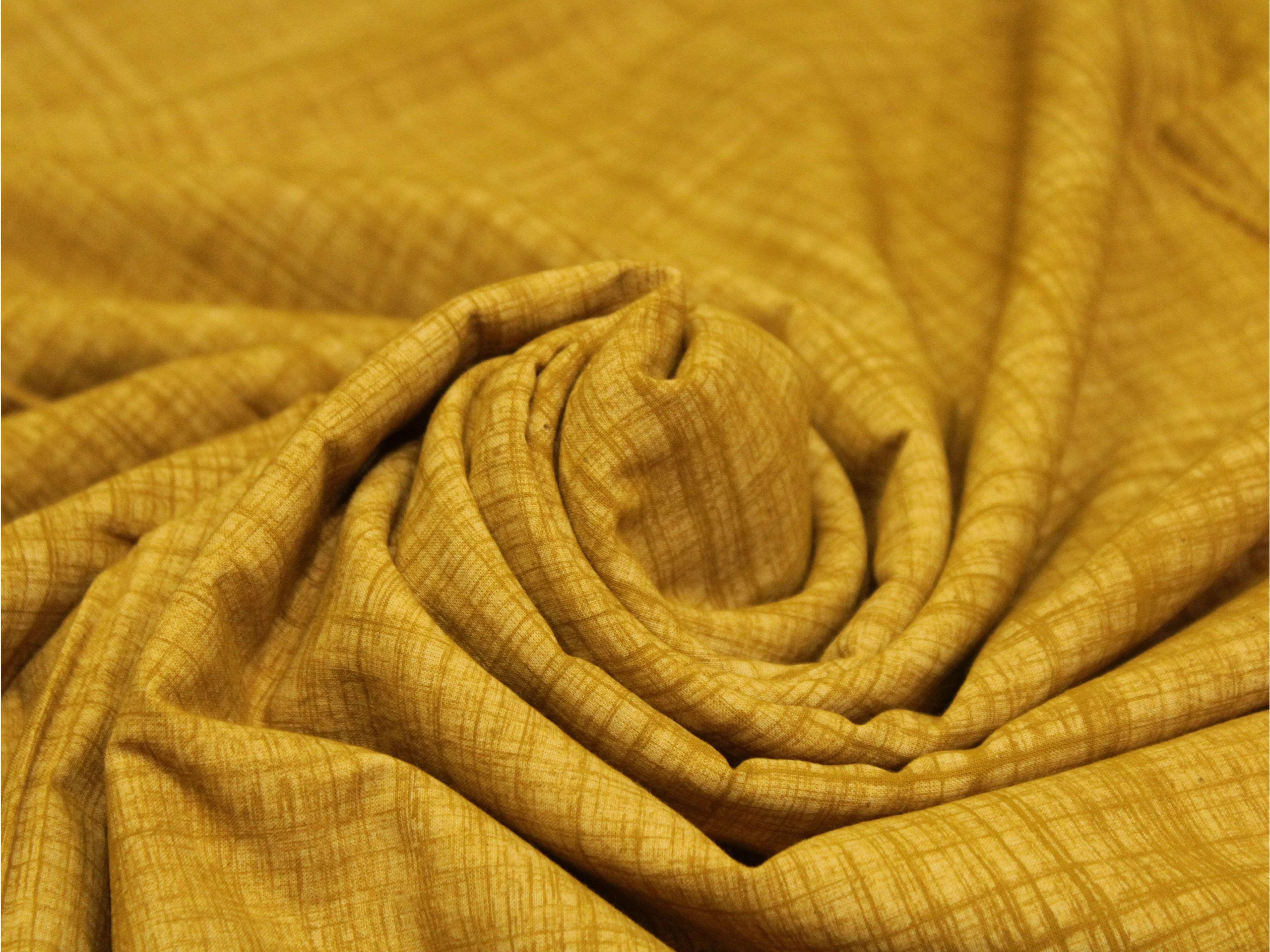 Yellow cotton hand block printed fabric with subtle textured lines, soft and draped