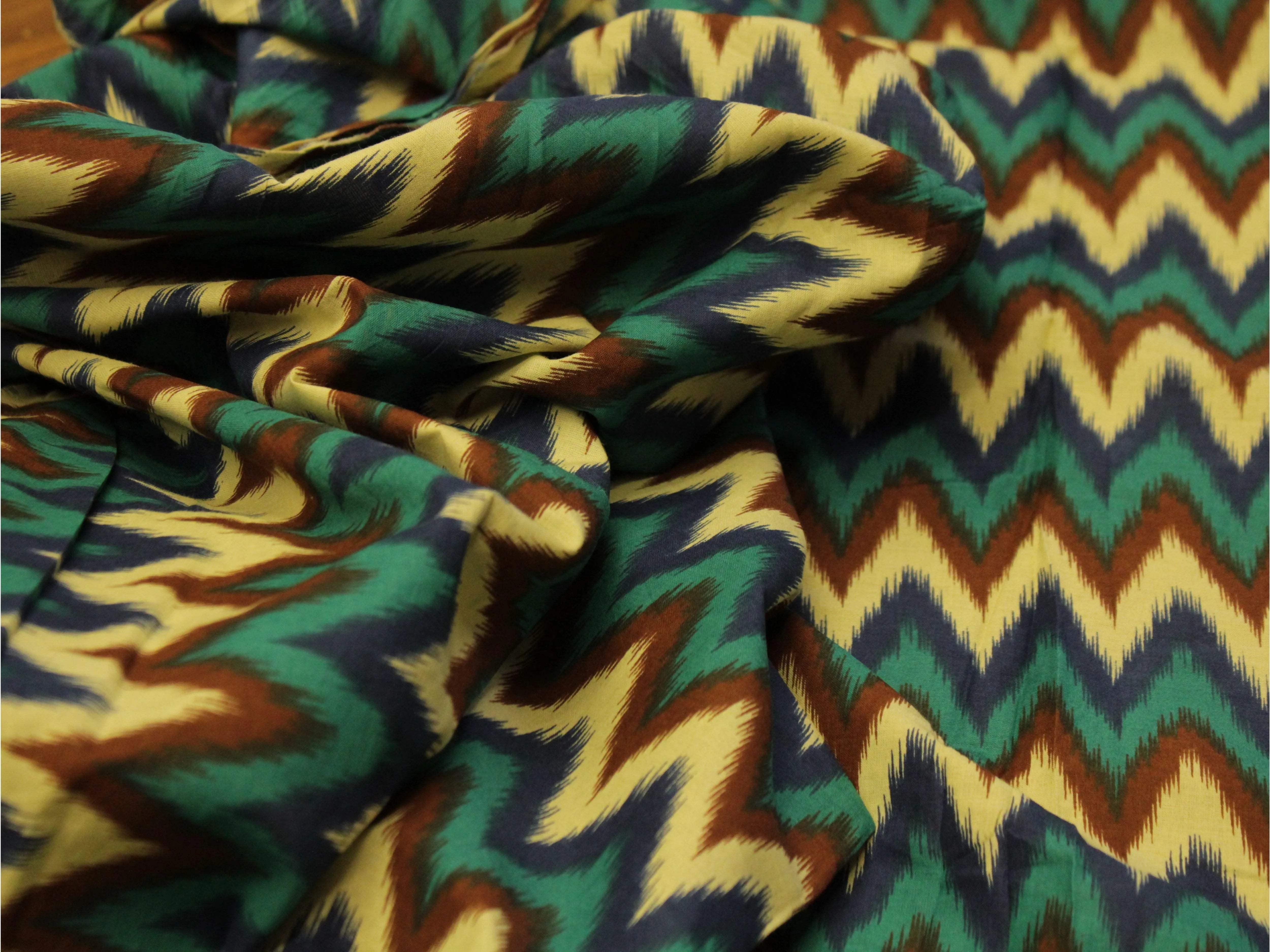 Multicolor chevron printed cotton fabric with green, blue, brown, and cream zigzag pattern