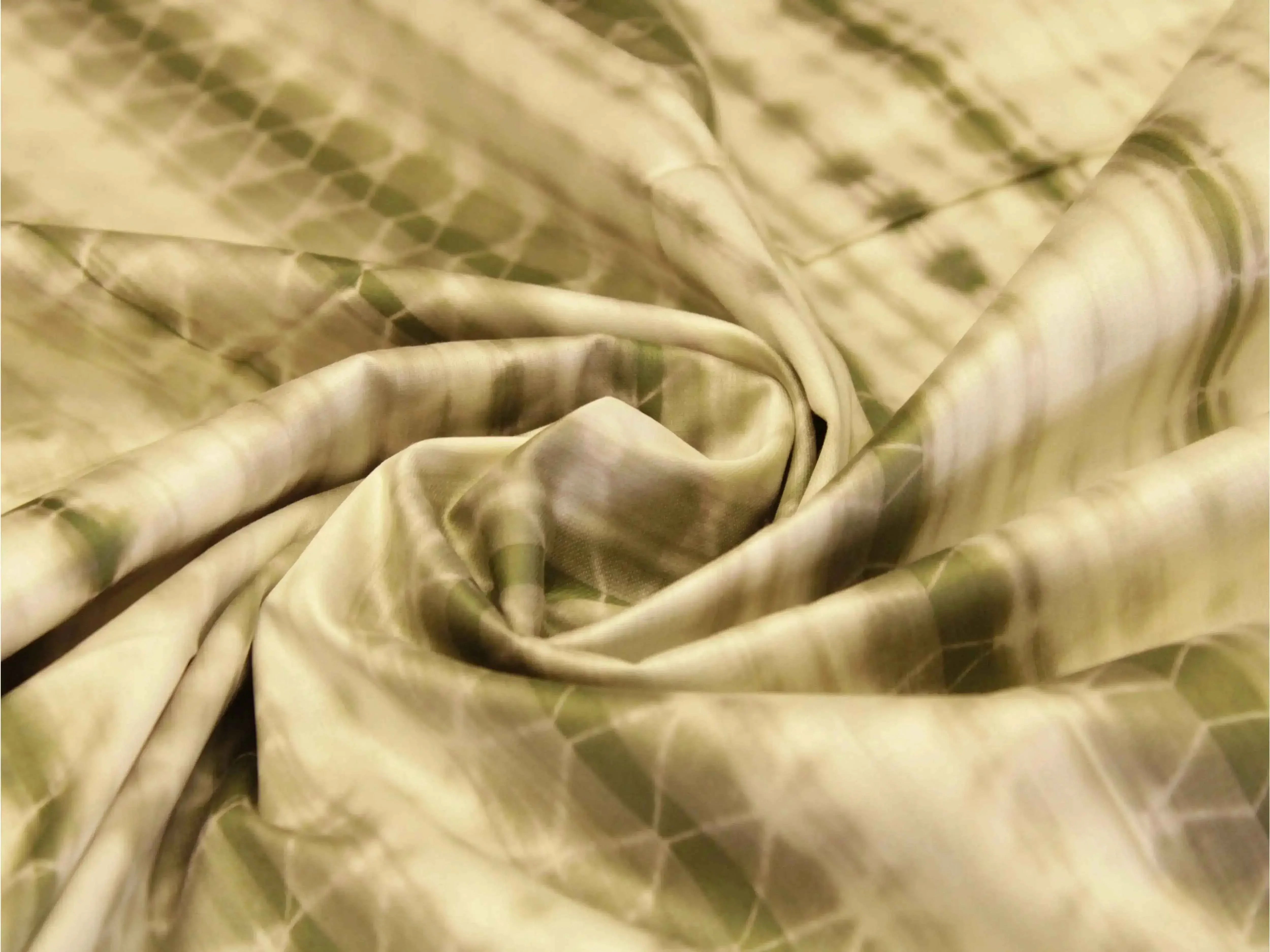 Dusty green cotton satin shibori printed fabric with abstract tie-dye patterns
