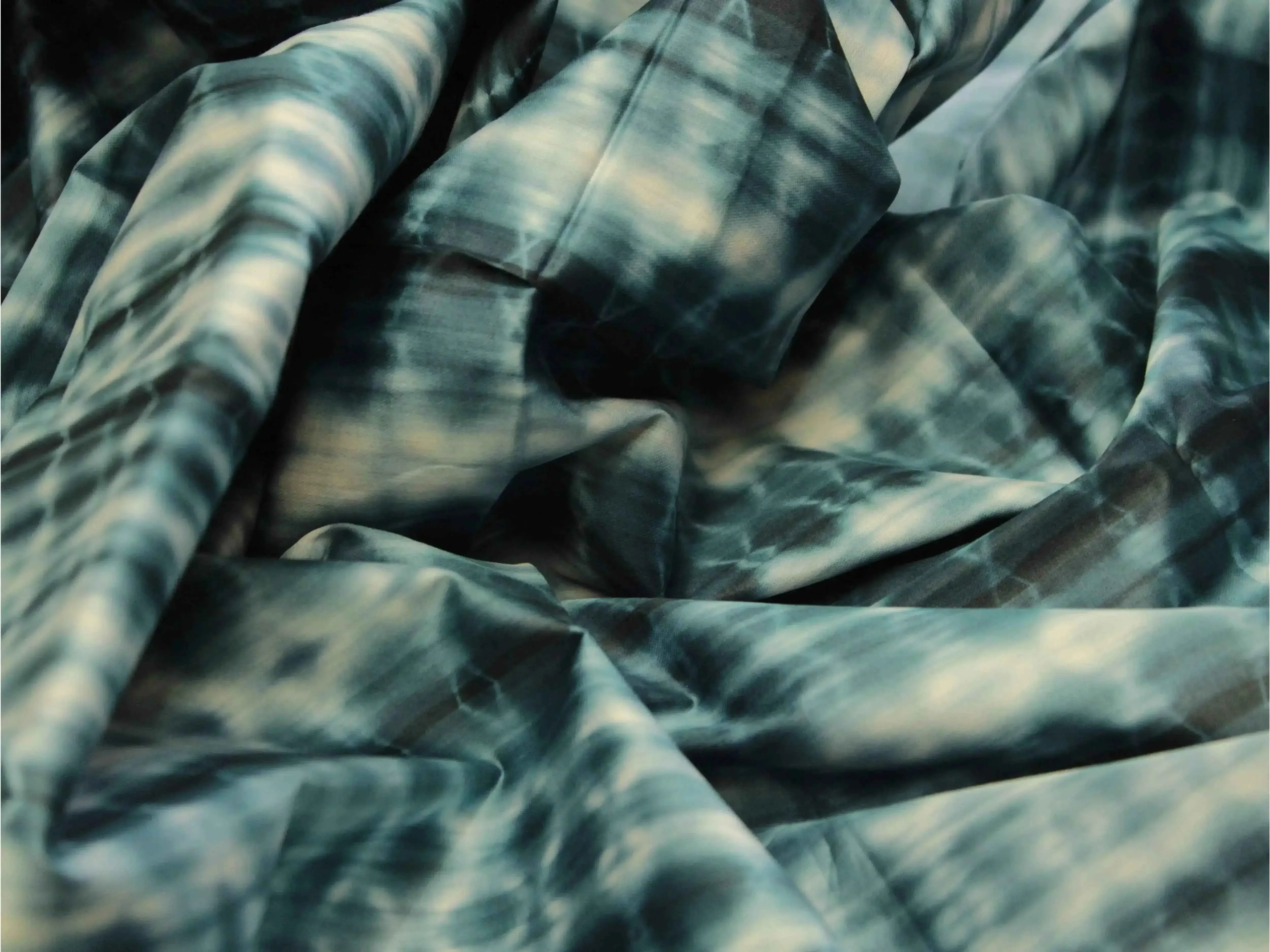 Peacock blue shibori printed cotton satin fabric with abstract tie-dye pattern