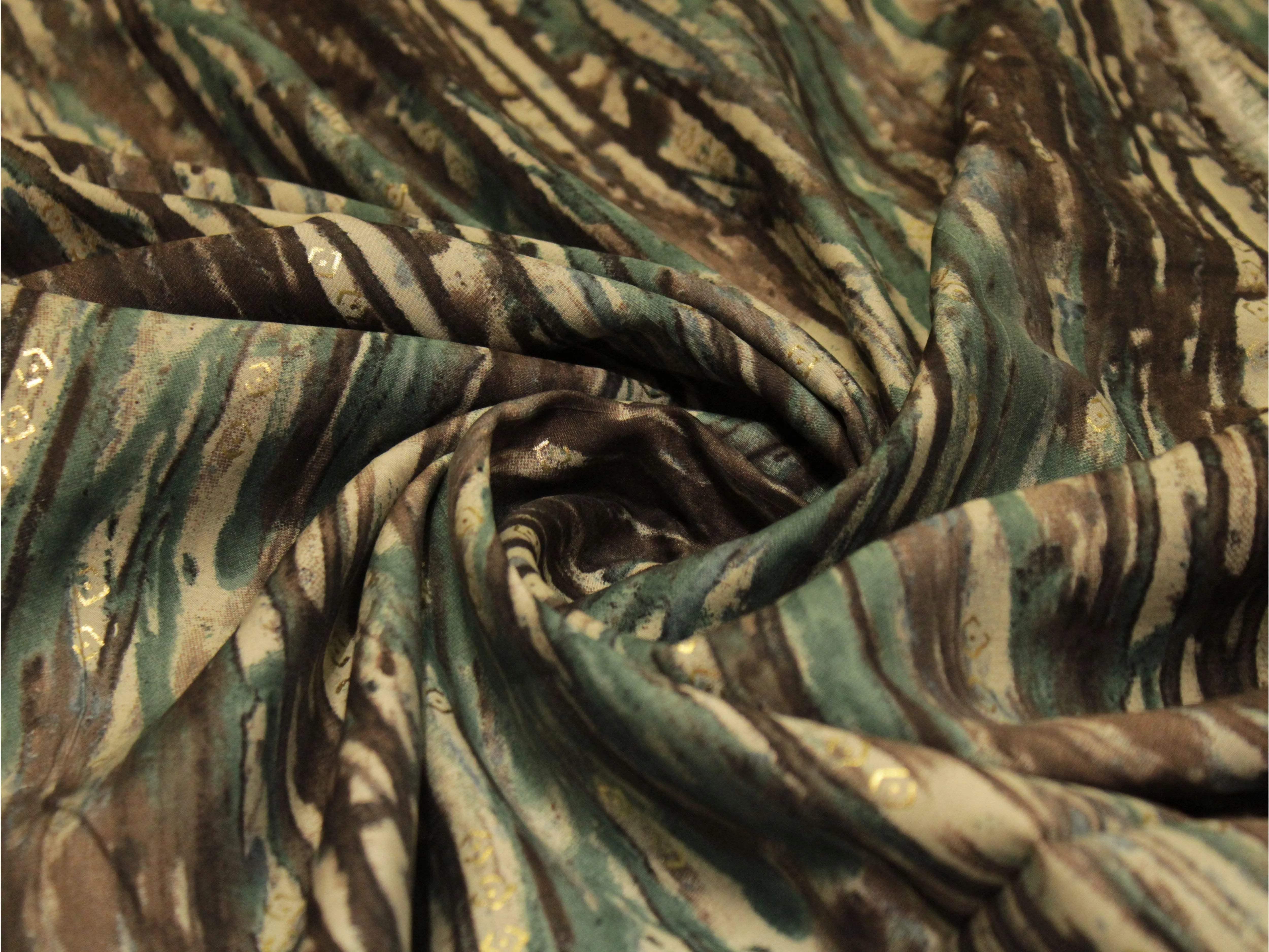 Abstract digital print muslin silk fabric with green, brown, and gold patterns, swirled