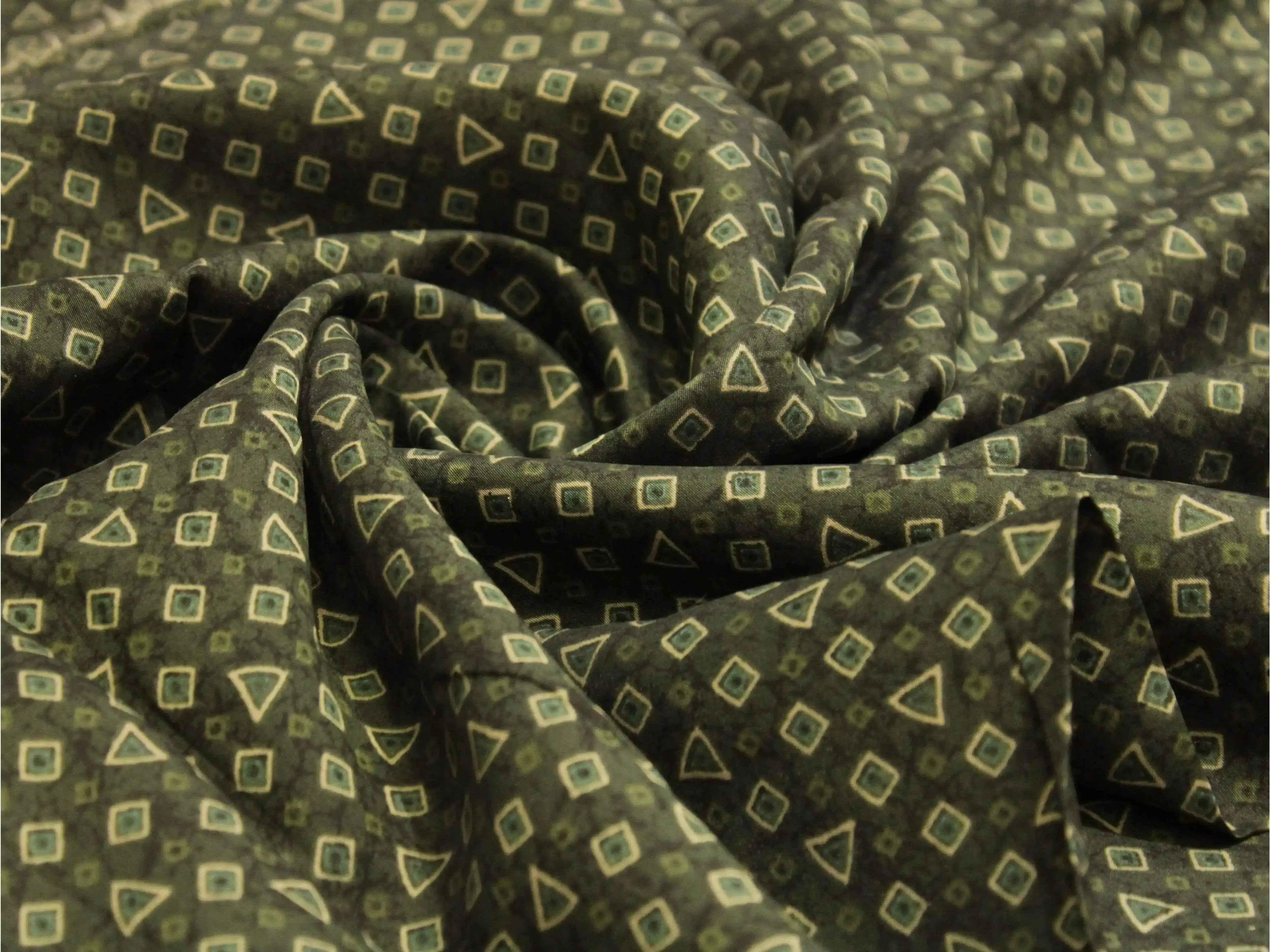 Olive green muslin silk fabric with geometric print, diamond and triangle patterns