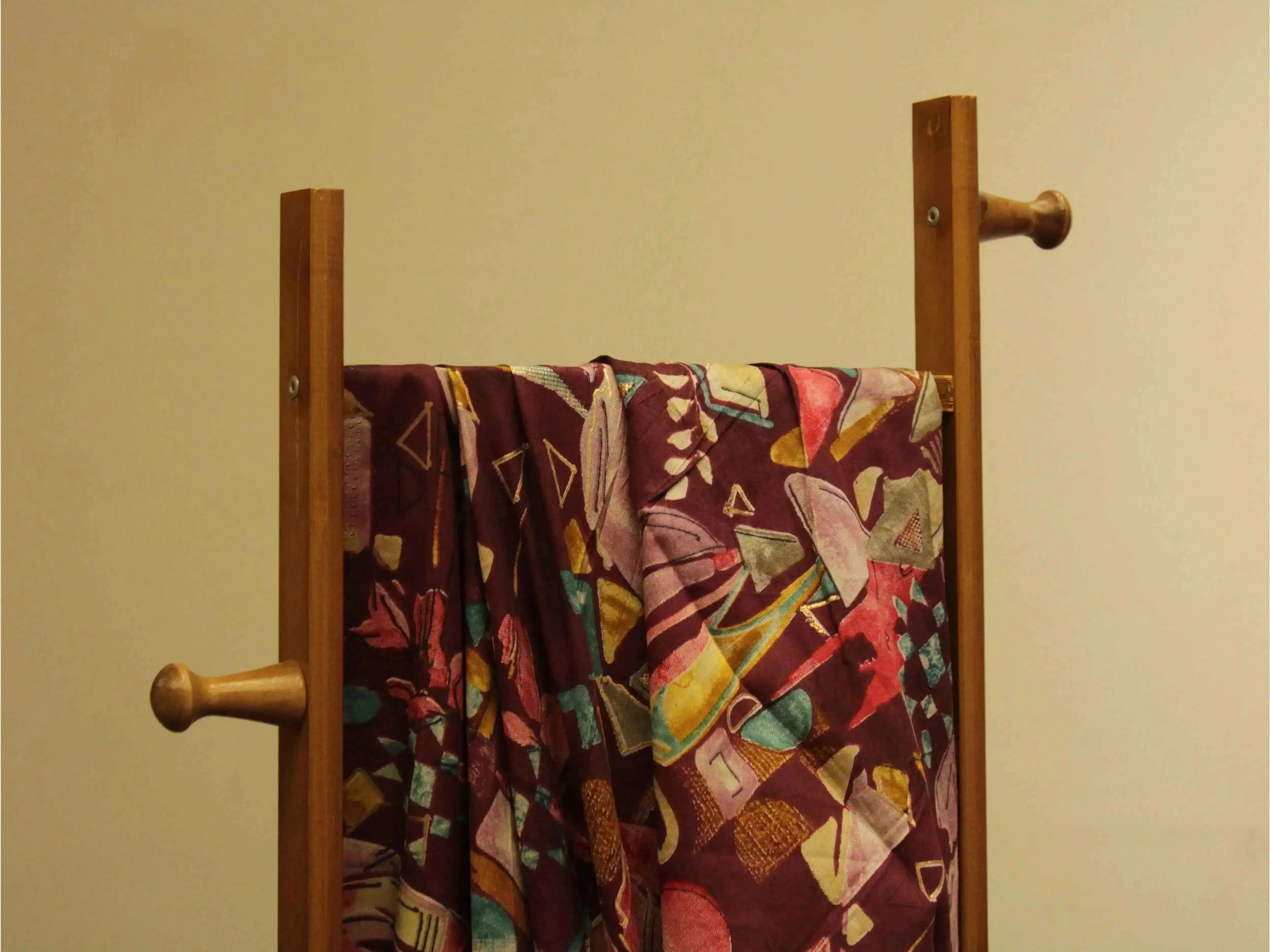 Multicolor abstract digital print muslin silk fabric draped on wooden stand