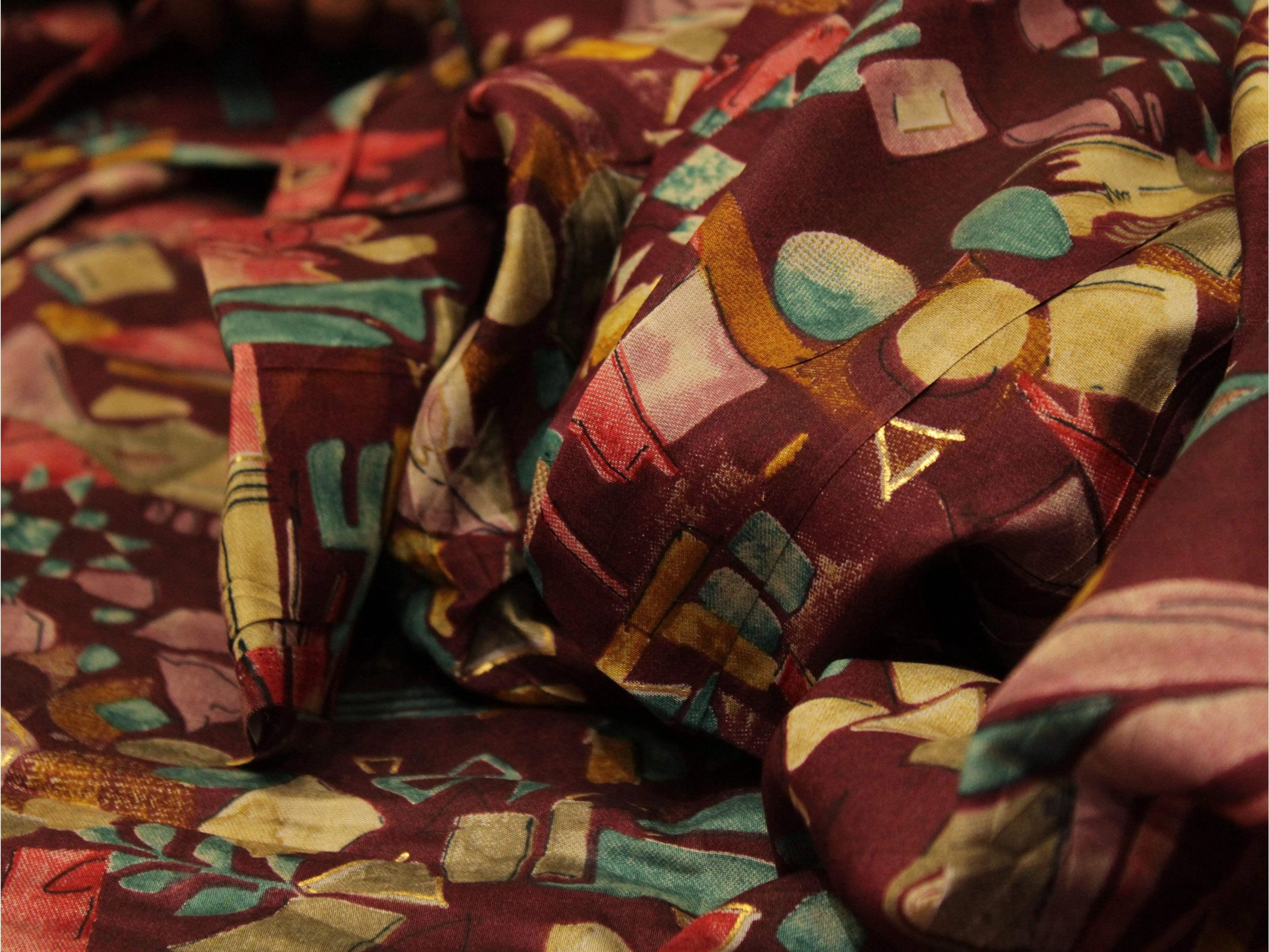 Maroon muslin silk fabric with abstract digital print and vibrant multicolor patterns
