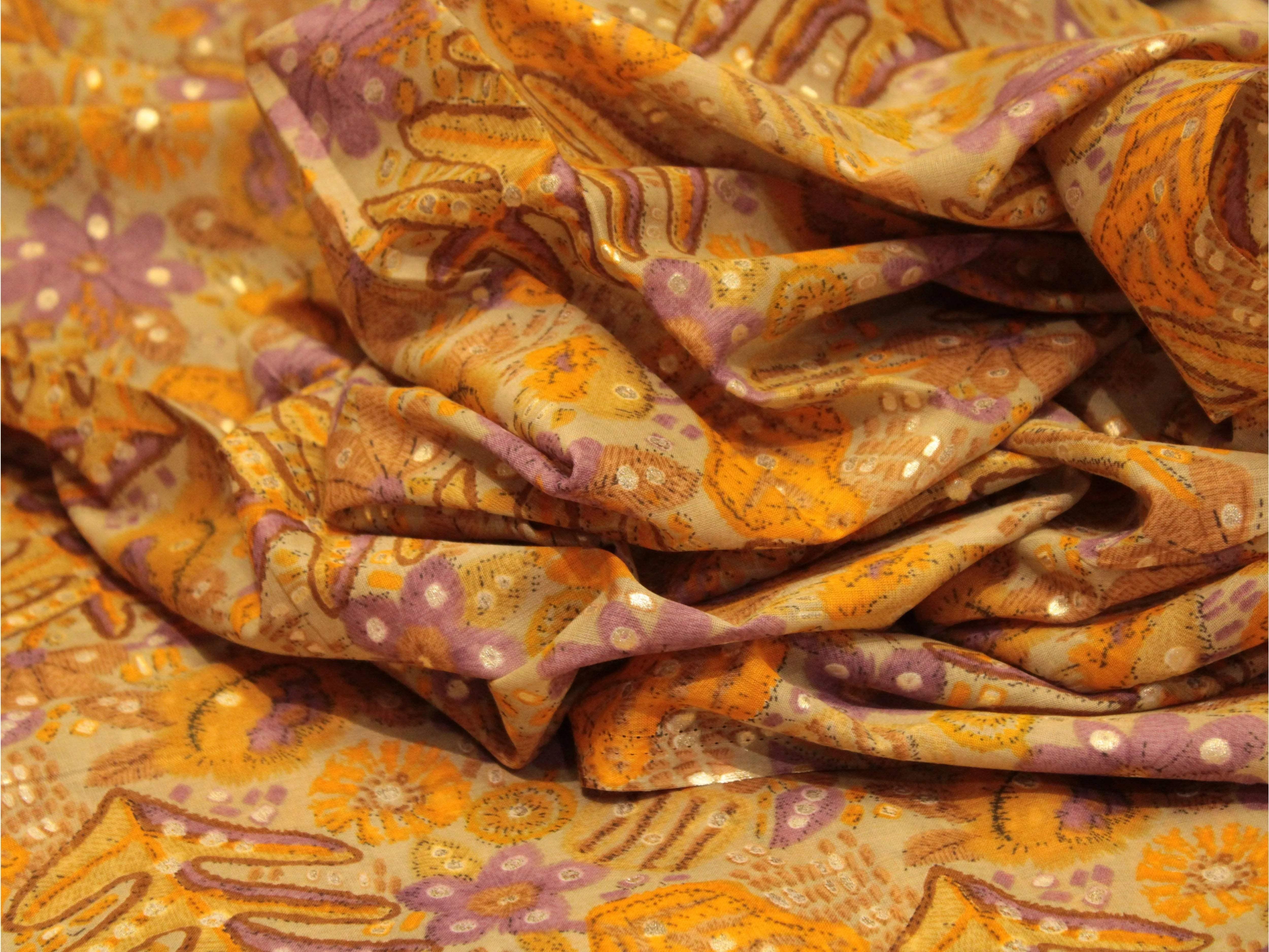 Lightweight cotton fabric with orange and purple floral prints and delicate patterns