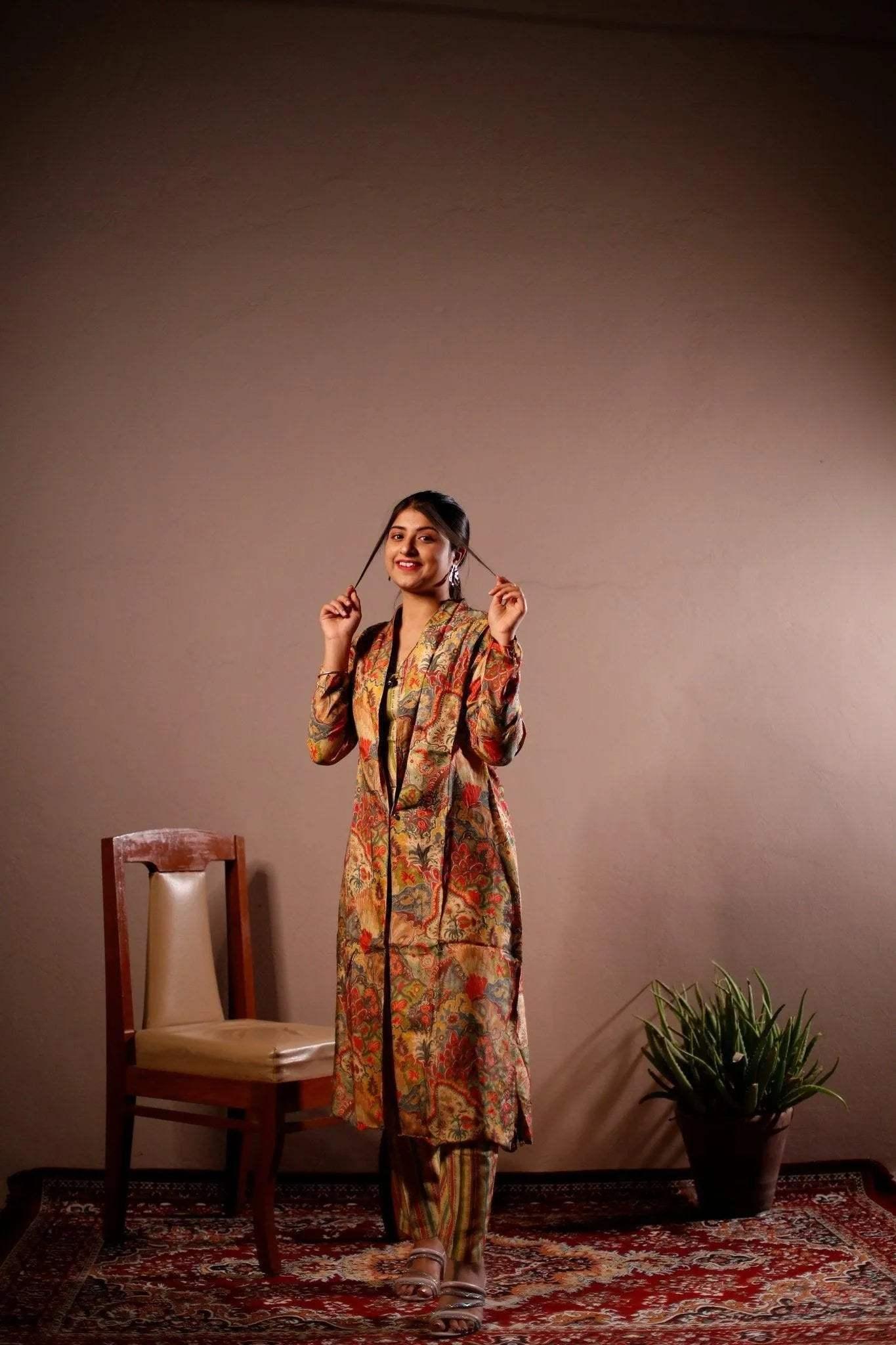 Woman in a floral printed blazer and pants set, standing on a patterned rug indoors.