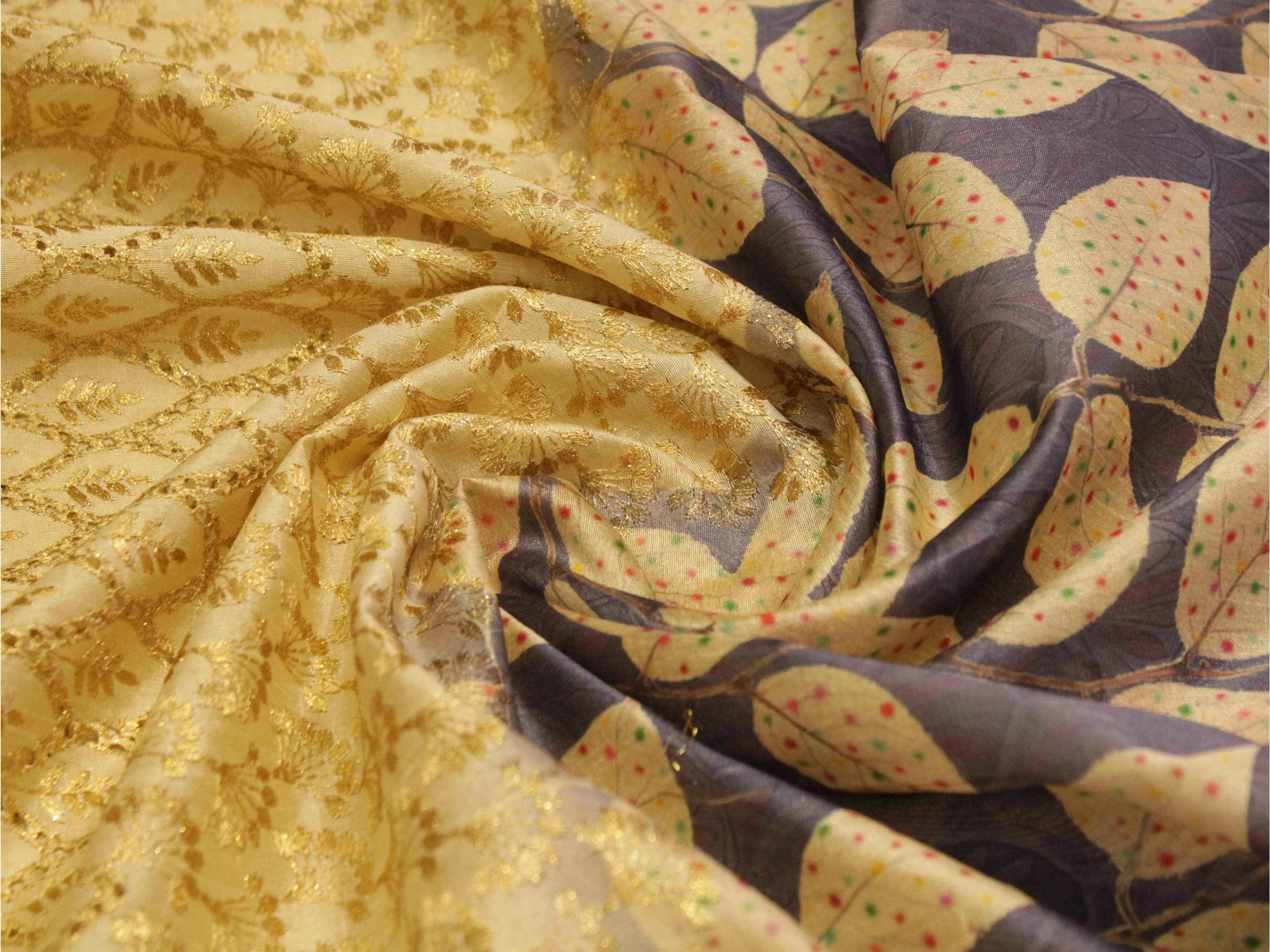 Gold silk fabric with digital leaf print and intricate brocade pattern, premium Indian textile