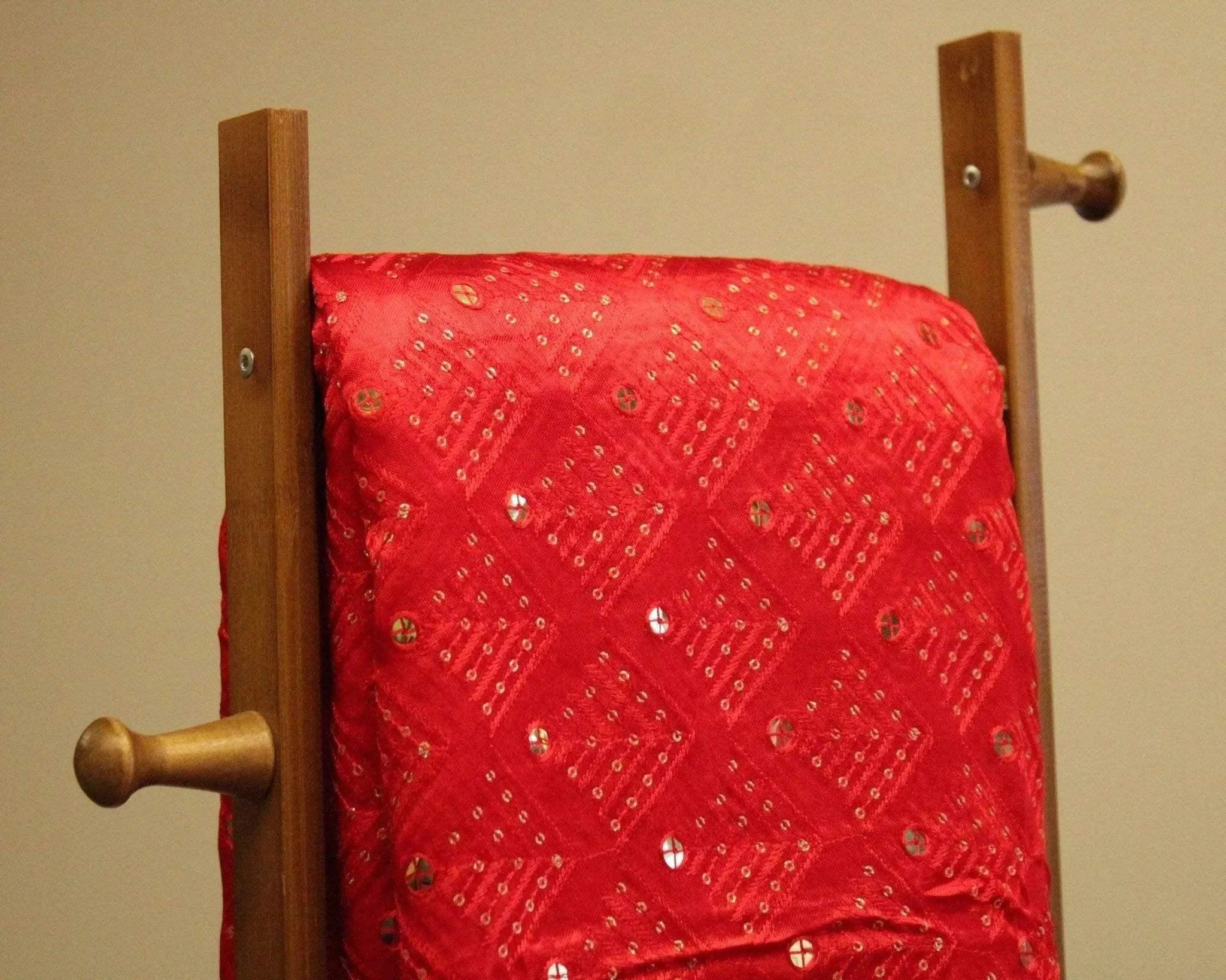 Red Gaji silk fabric with thread and mirror work on display stand