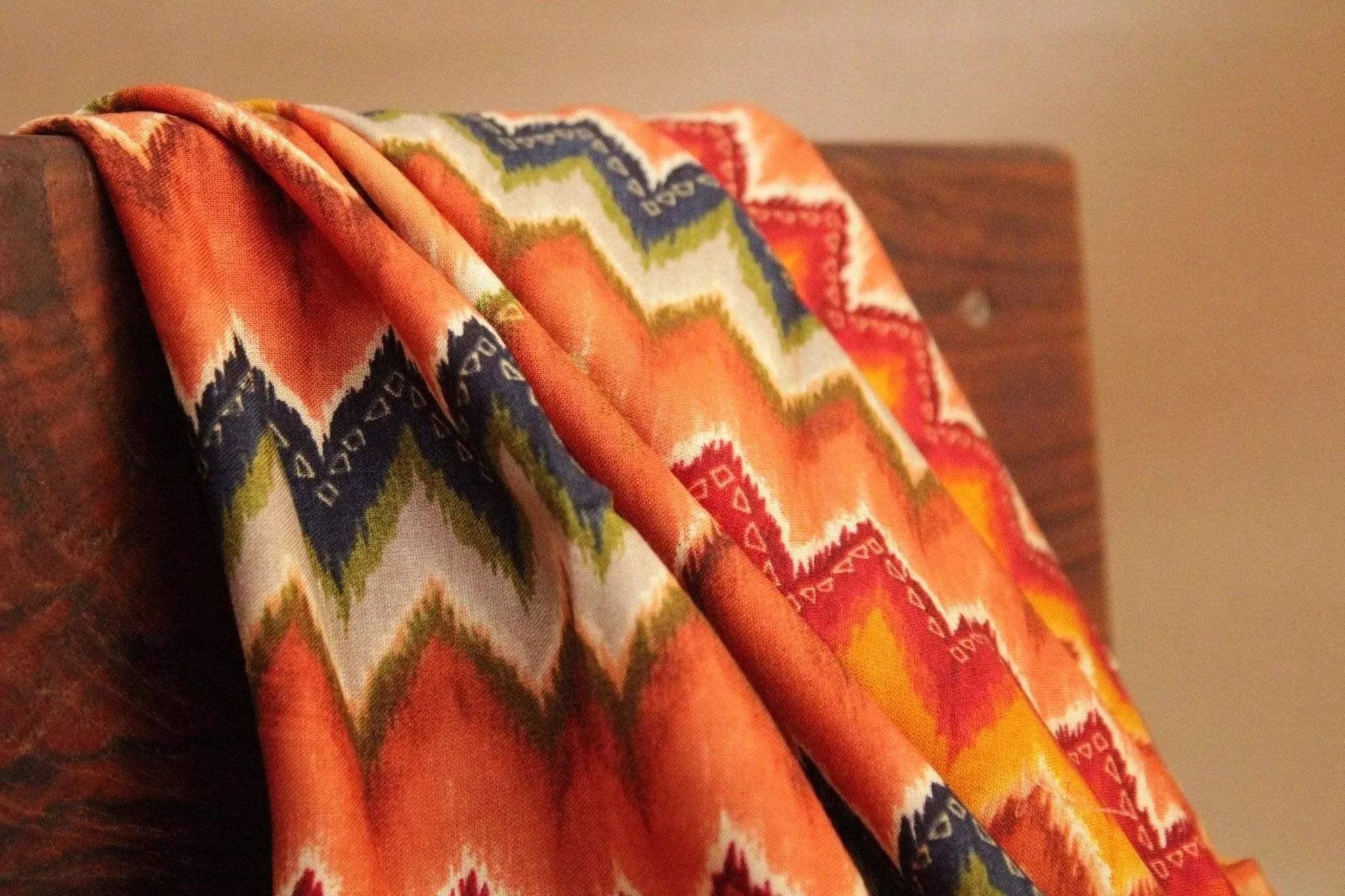 Amber Italian rayon fabric with vibrant zigzag pattern in orange, blue, and green hues