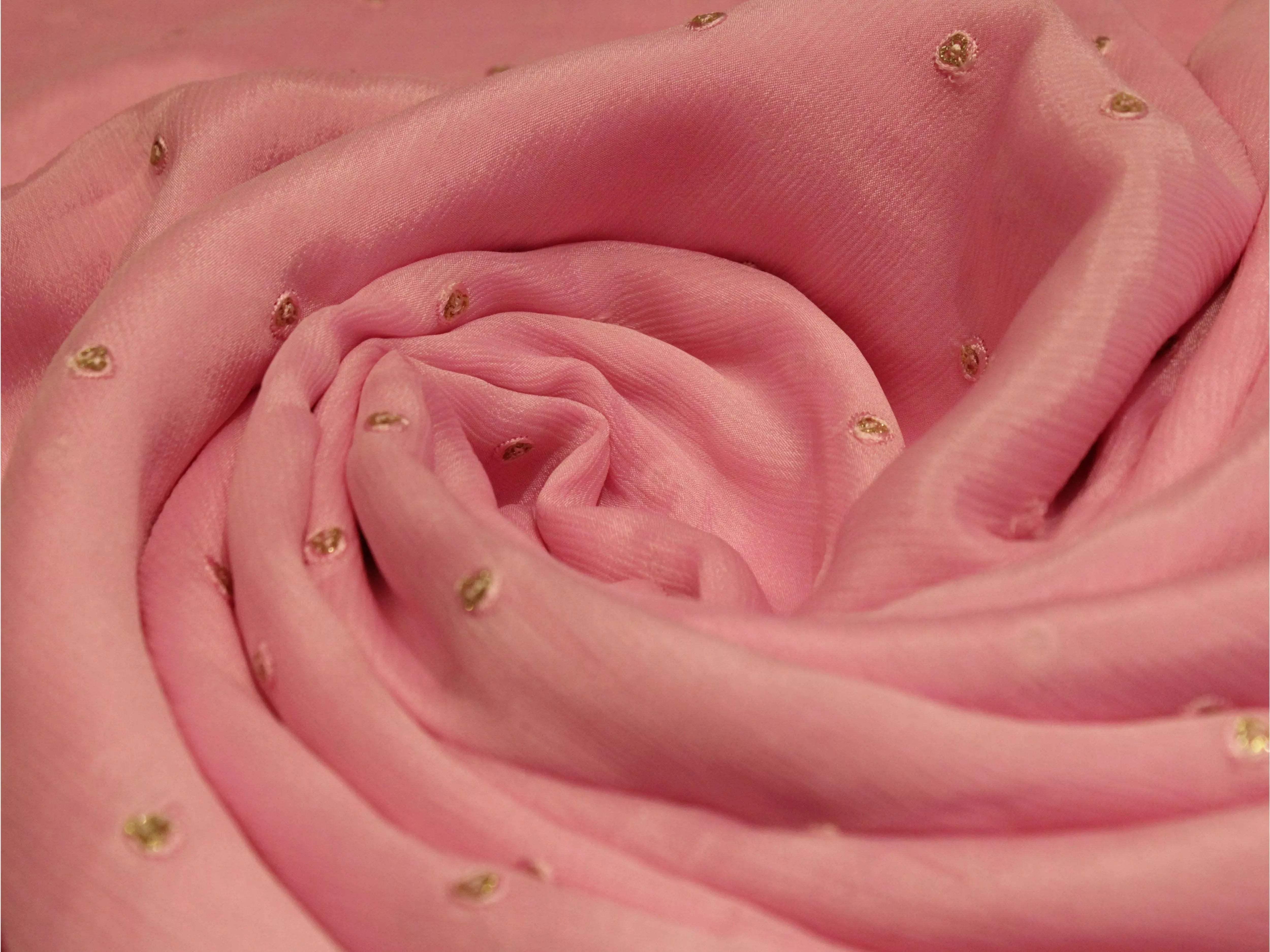 Pure pink Chinon fabric with minimal gold buti embroidery, soft texture, close-up view