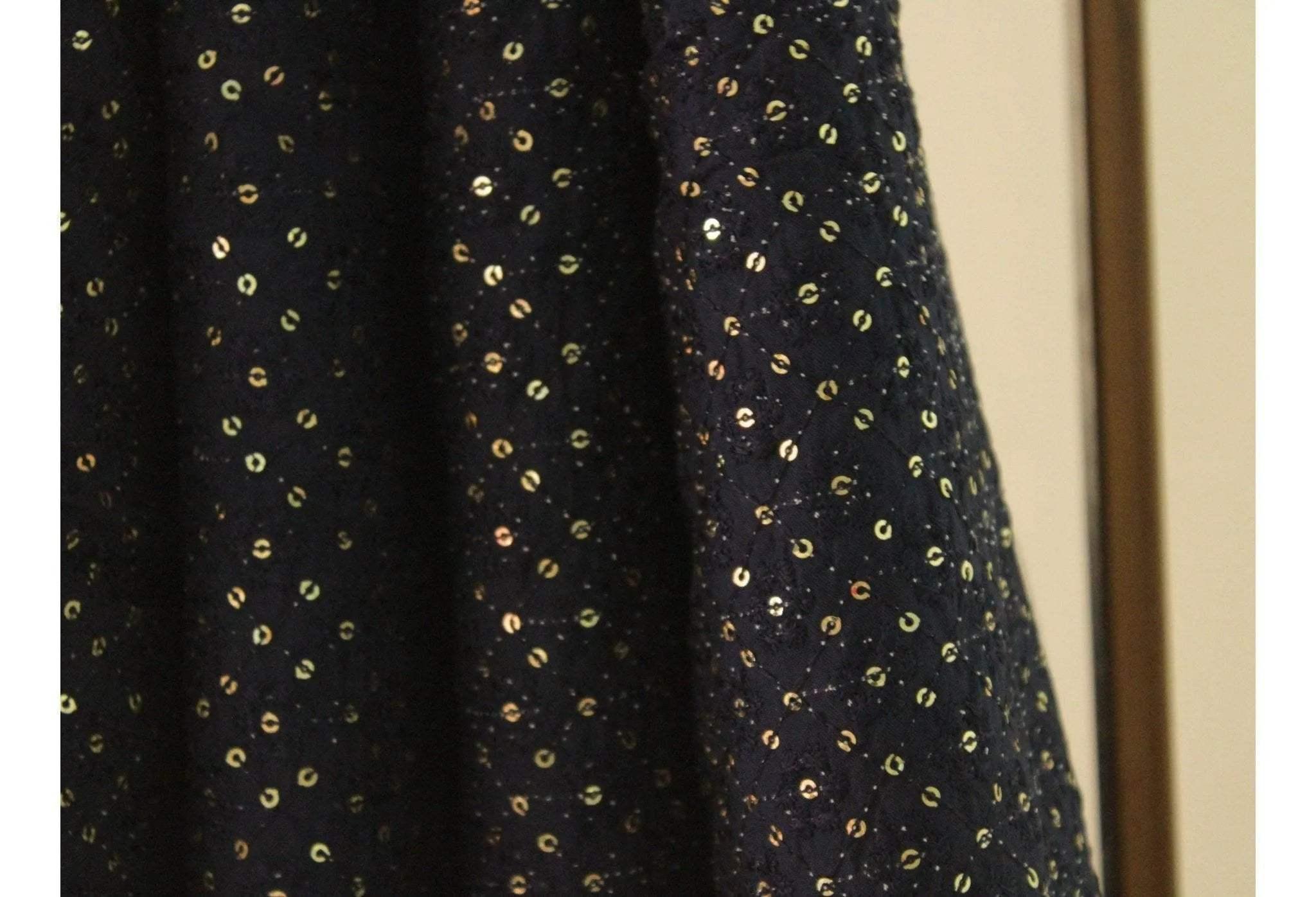 Dark blue upada silk fabric with gold sequins and thread embroidery, close-up