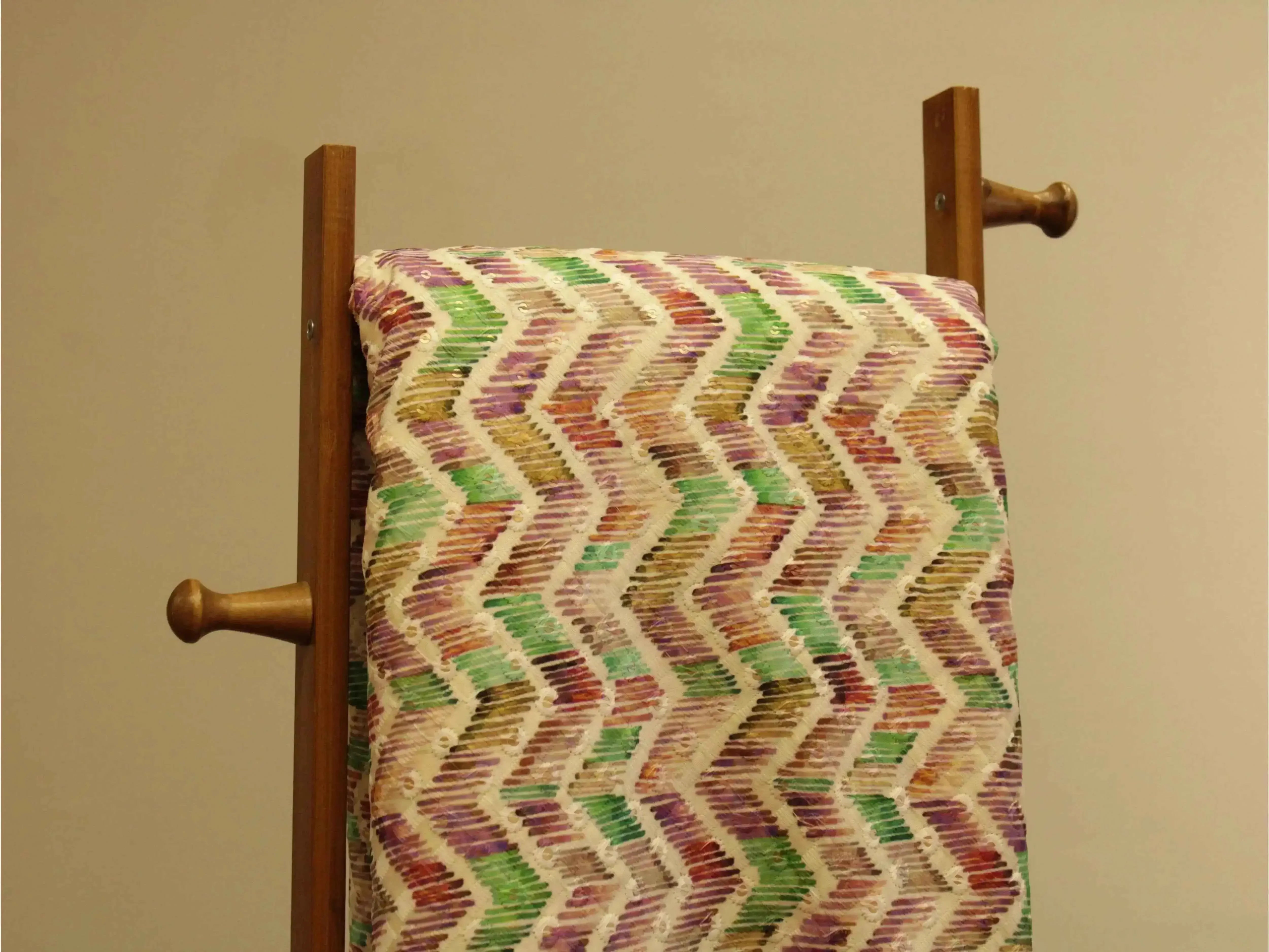 Multicolor zigzag digital print silk fabric draped on a wooden stand
