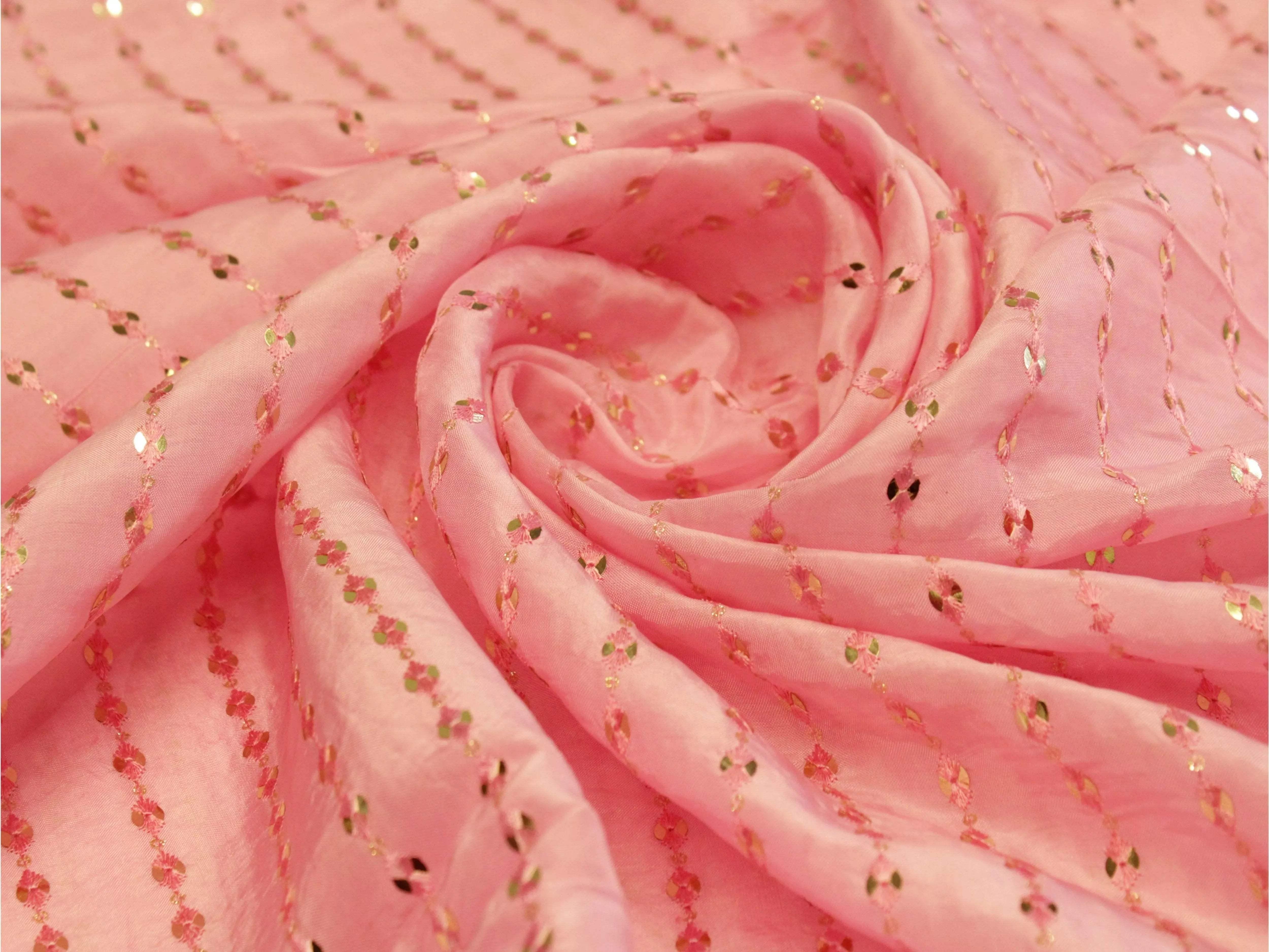 Pink mirror work fabric with gold embroidered detailing, ideal for ethnic wear
