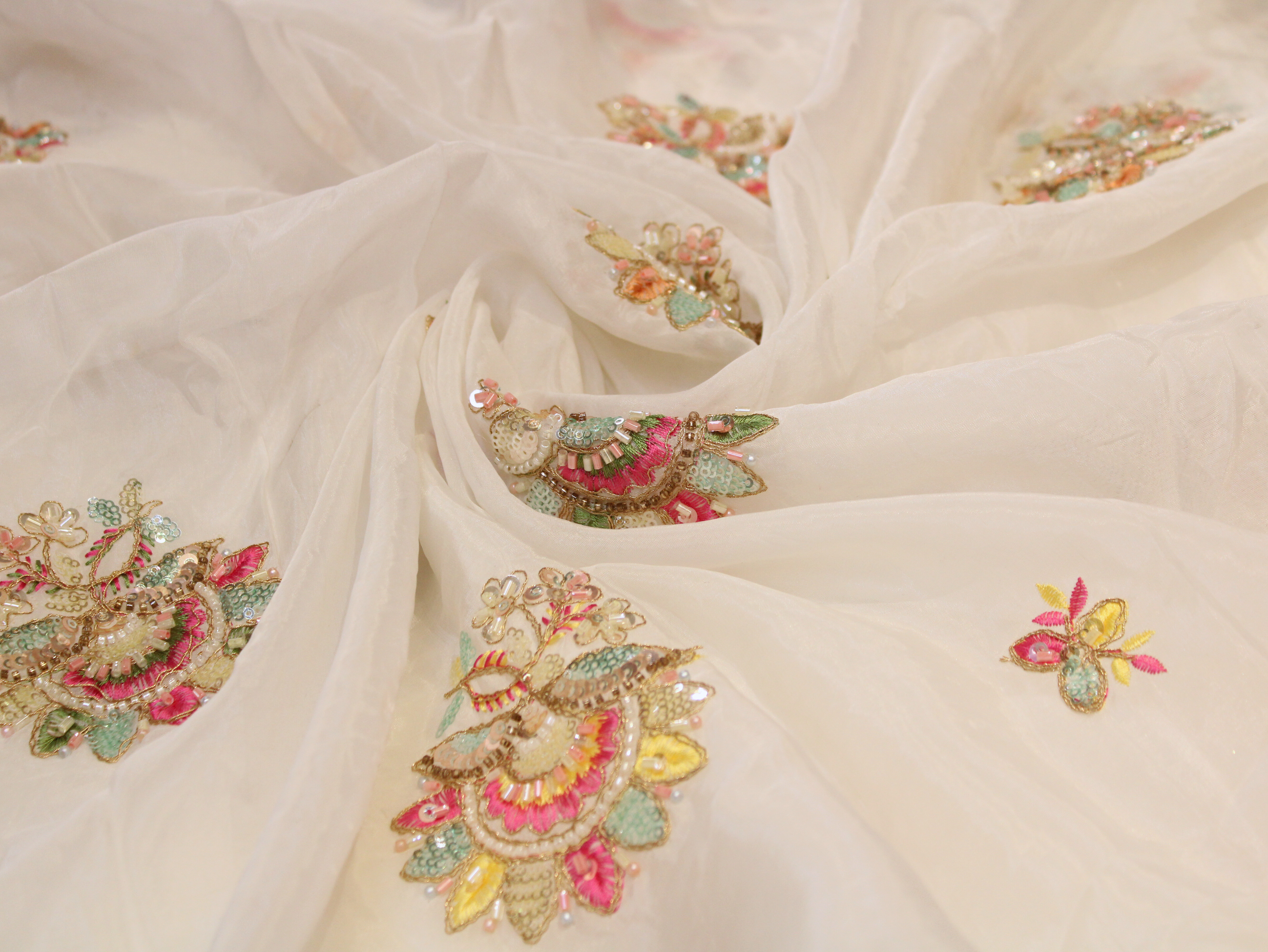 White Indian fabric with colorful floral hand embroidery and sequins detail