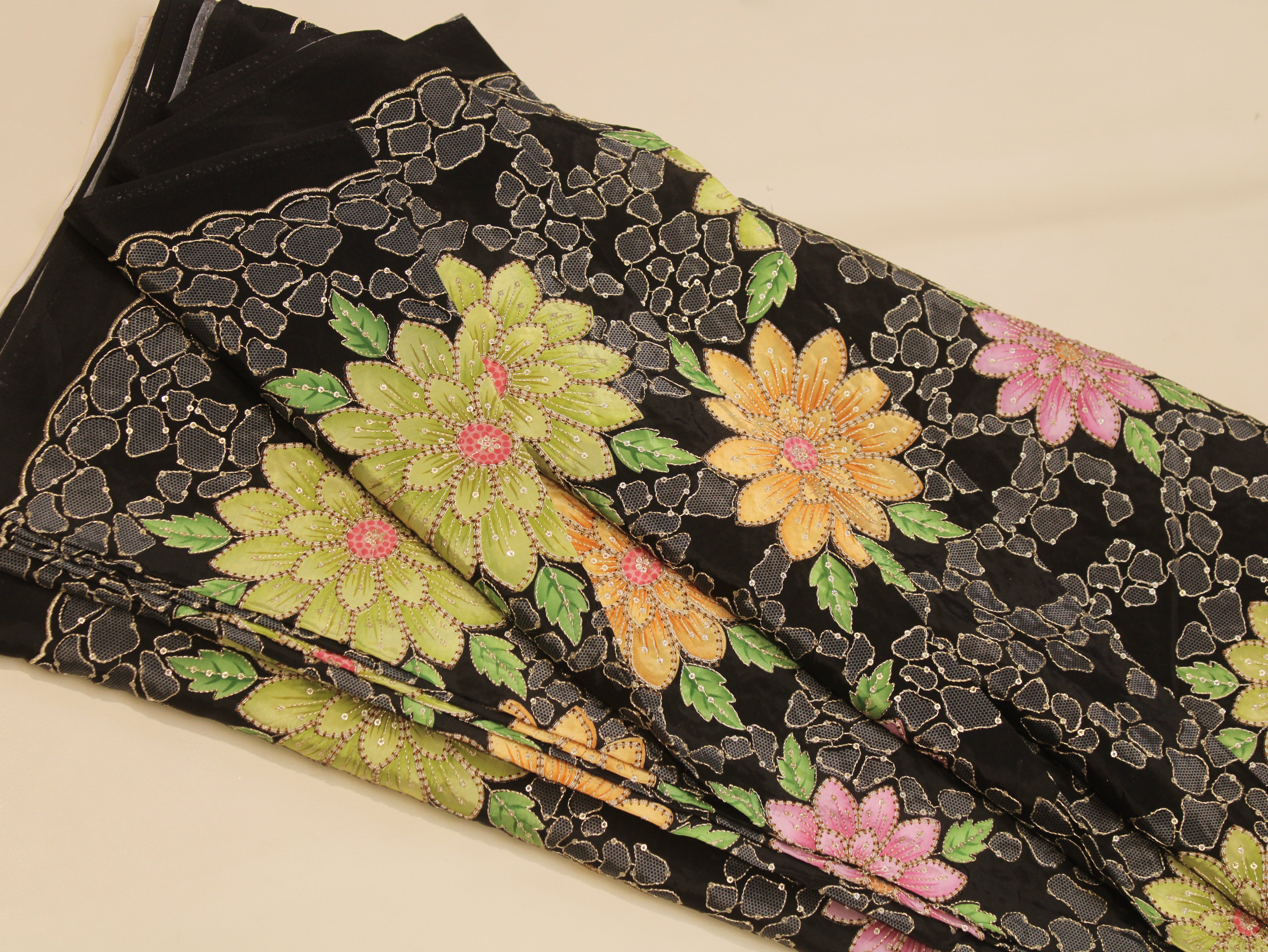 Embroidered fabric with floral patterns on a black background